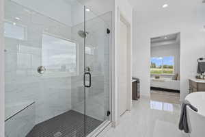 Bathroom featuring tile floors, separate shower and tub, and vanity