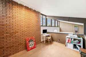 Playroom with natural light, exposed bricks, and TV