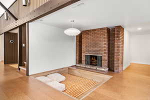 Living room featuring a brick fireplace and carpet