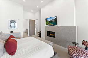 Bedroom featuring a fireplace, tile flooring, and TV