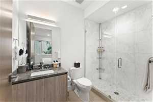 Full bathroom featuring tile floors, toilet, mirror, vanity, and shower cabin
