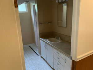 Bathroom featuring multiple mirrors and vanity