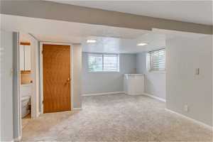 Basement with carpet and natural light