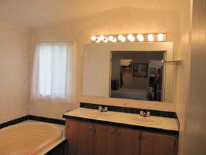 Master Bathroom, mirror, dual vanity, and a bathtub