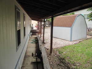 View of side of home with a yard