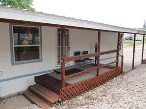 View of exterior entry with a deck