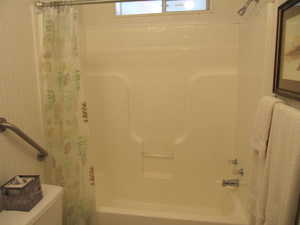 Main bathroom featuring shower curtain and shower / bathtub combination