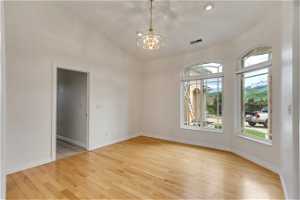 Empty room with hardwood floors and natural light