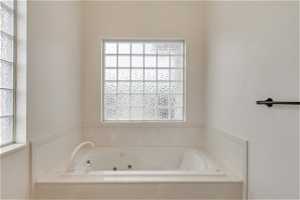 Bathroom with a healthy amount of sunlight and a tub