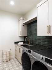 Laundry area with light tile floors and washer / dryer