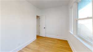 Unit 1 Spare room featuring natural light and hardwood flooring