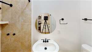 Unit 3 Half bath featuring microwave, mirror, washbasin, and toilet