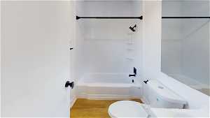 back 6 units Full bathroom featuring wood-type flooring, mirror, sink, bathing tub / shower combination, and toilet