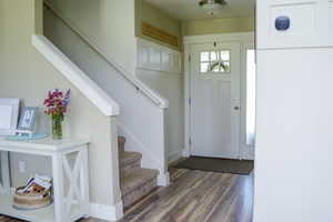 Wood floored foyer with natural light