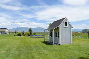 View of shed / structure with a lawn and a mountain view