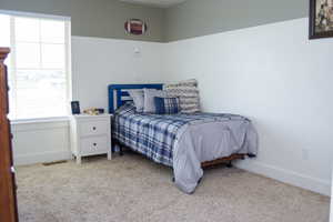 Carpeted bedroom featuring natural light