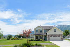 View of front of house featuring a mountain view and a front lawn