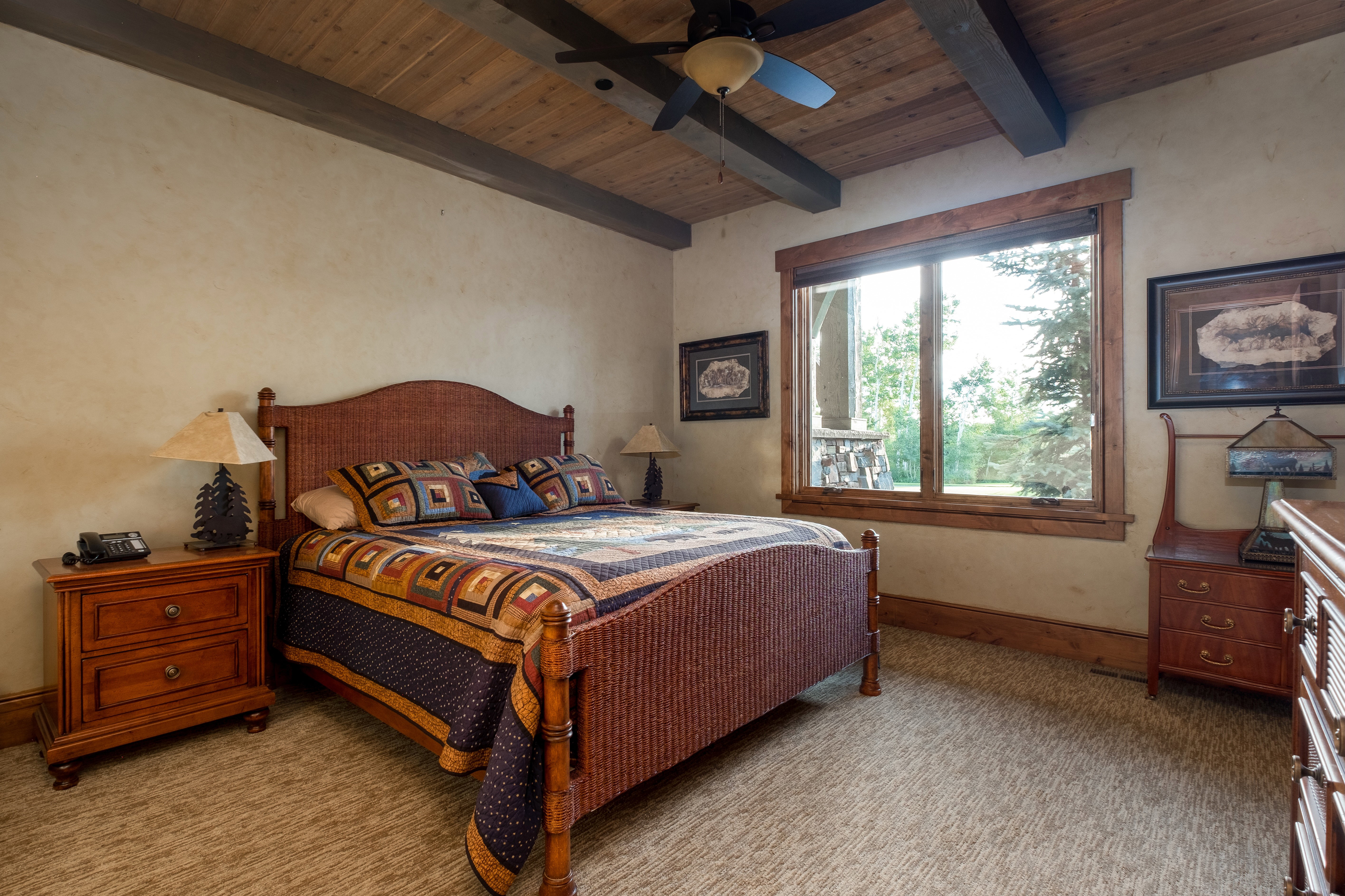 Bedroom featuring beamed ceiling, baseboards, ceiling fan, light colored carpet, and wood ceiling