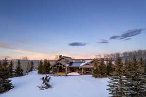 View of front of house with a chimney and a patio