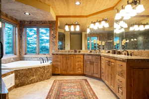 Full bath featuring a sink, wooden ceiling, wooden walls, and a bath