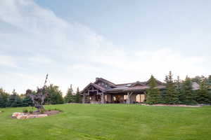 View of front of home featuring covered porch and a front yard