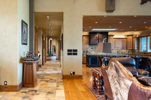 Kitchen with backsplash, recessed lighting, baseboards, and brown cabinets