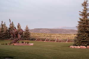 View of yard featuring fence, a mountain view, and a rural view