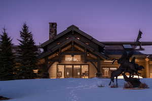 View of front facade with a chimney and french doors