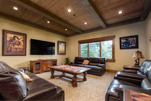 Living room featuring recessed lighting, beamed ceiling, light colored carpet, and wood ceiling