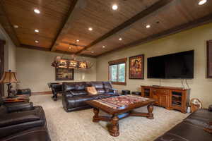Carpeted living area with baseboards, recessed lighting, beamed ceiling, and wood ceiling