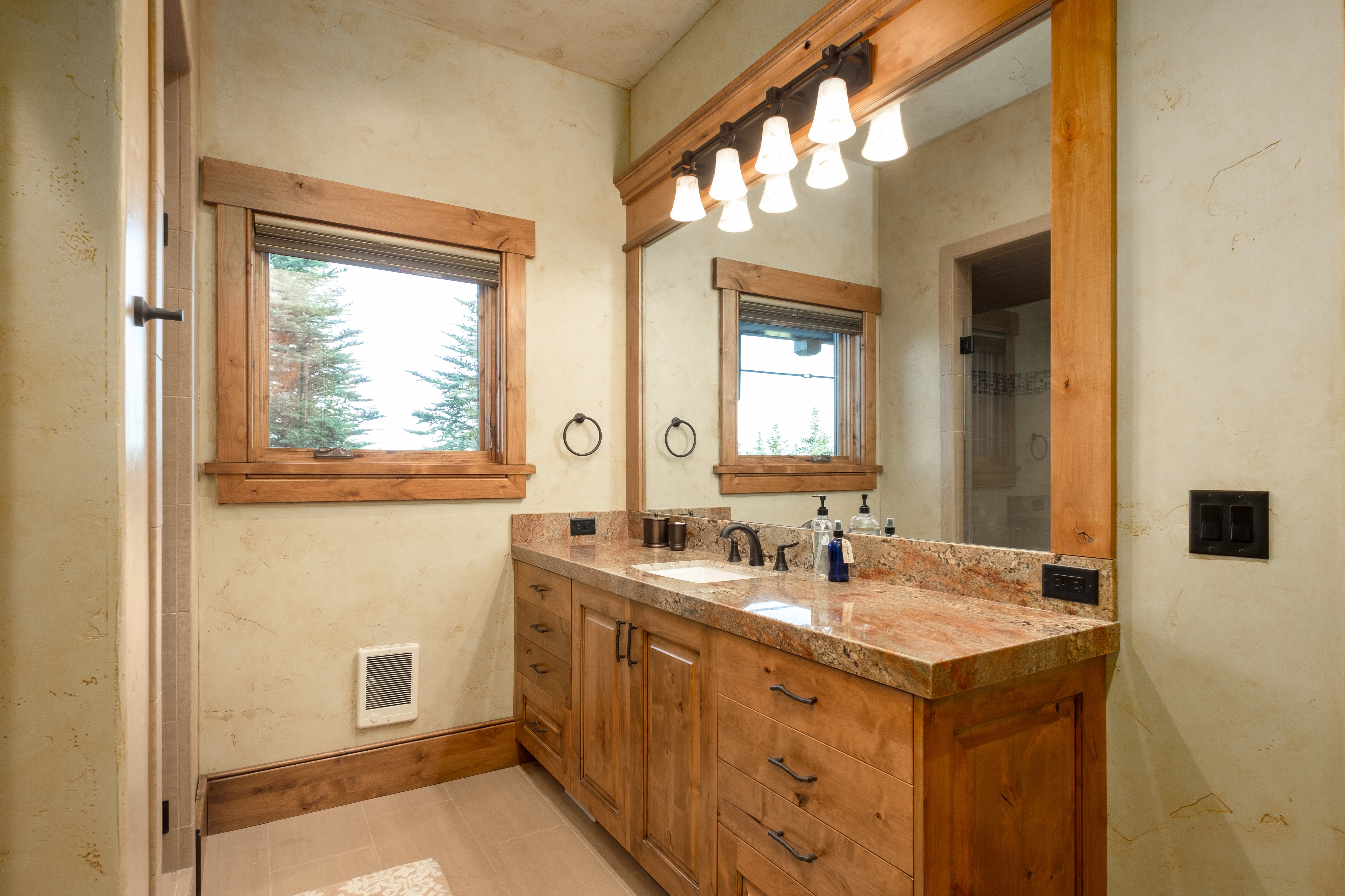 Bathroom with vanity, baseboards, and visible vents