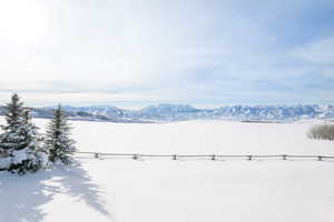 Snowy yard featuring a mountain view