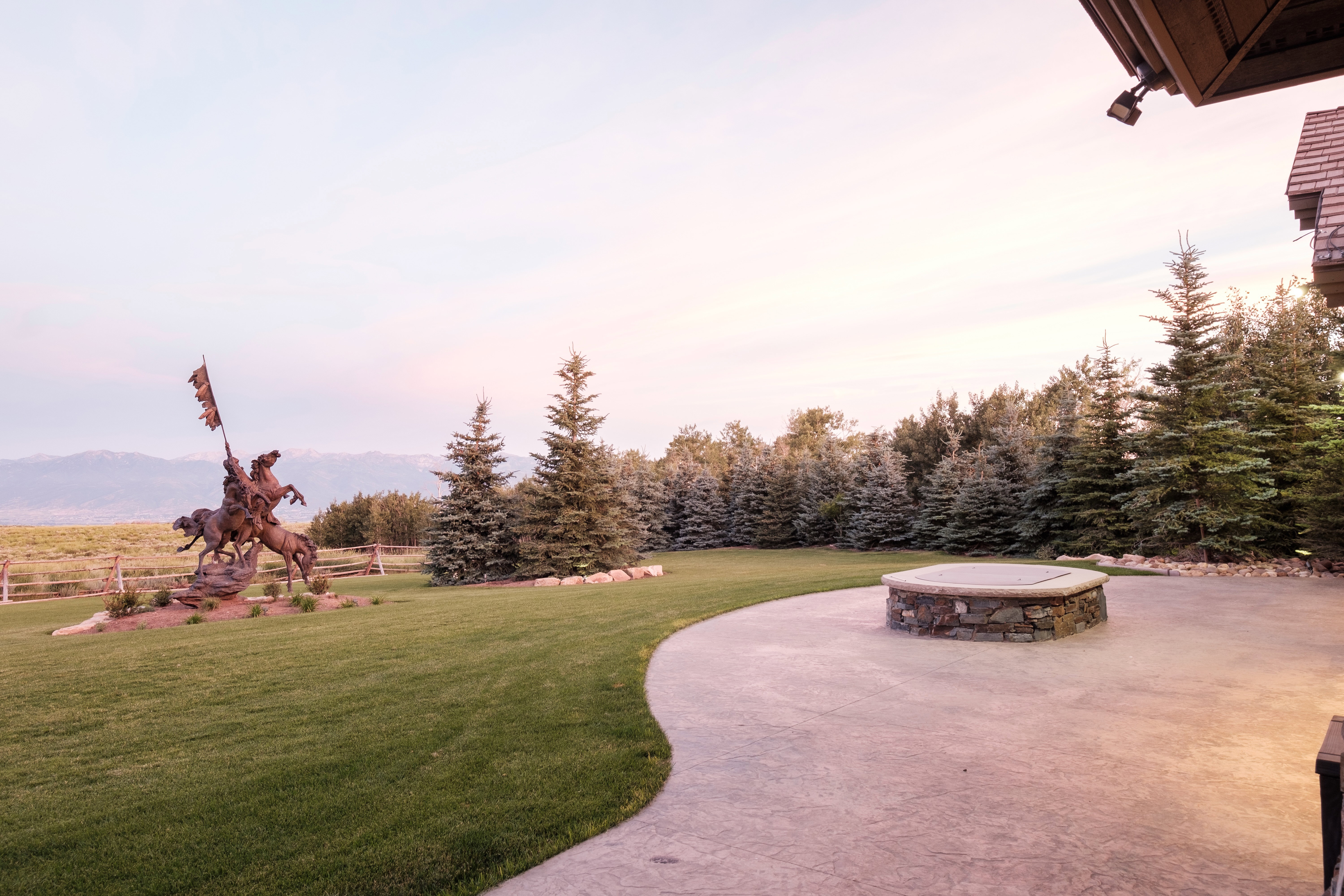 View of community featuring a lawn, a patio, and a mountain view