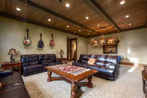 Carpeted living room with wood ceiling, baseboards, beamed ceiling, and recessed lighting