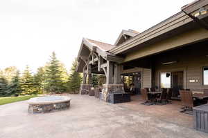 View of patio / terrace featuring outdoor dining area and an outdoor fire pit