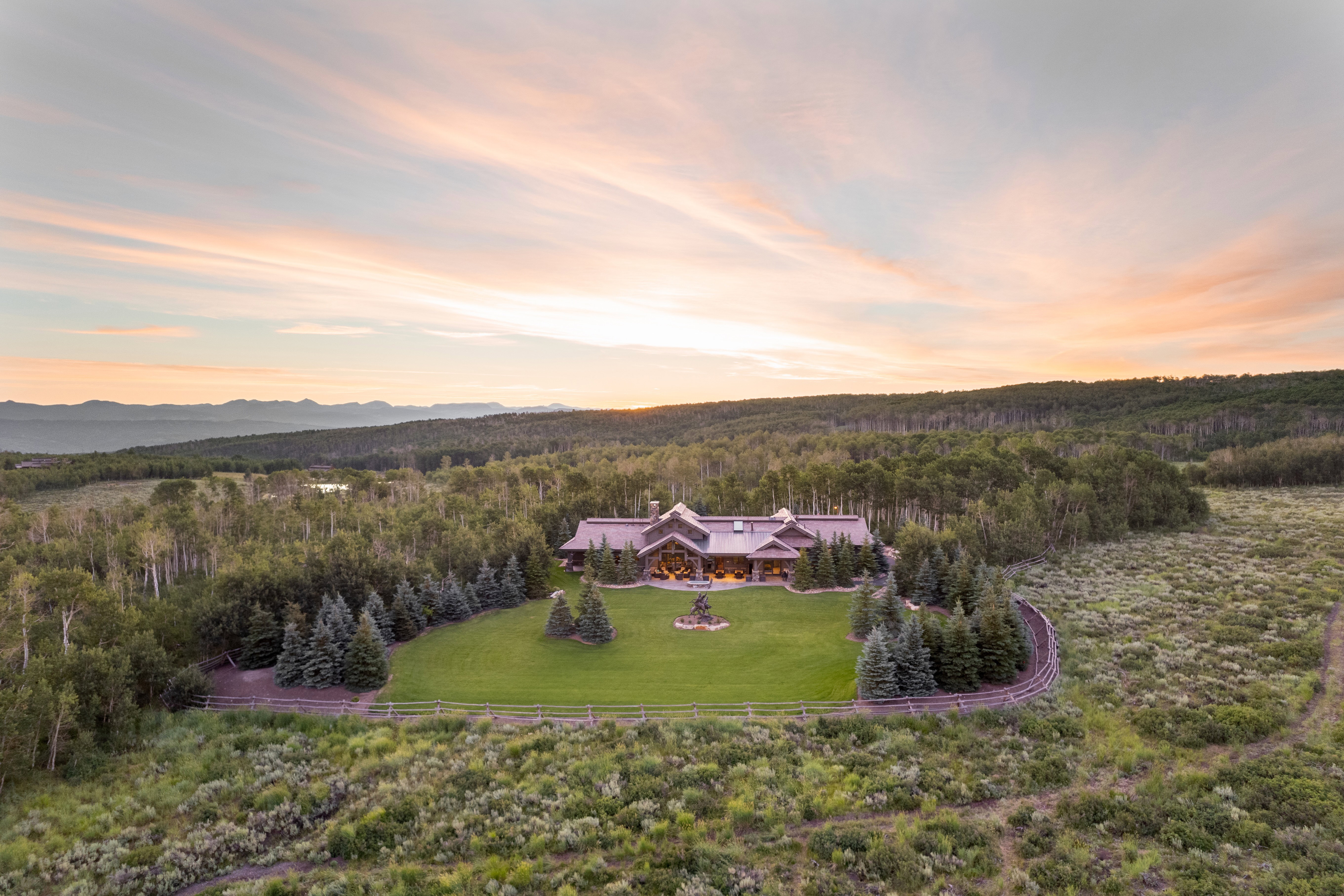 Birds eye view of property with a wooded view