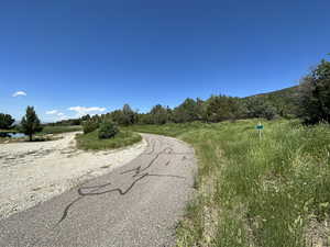 Lower northwest corner of property, across the road from private fishing lake