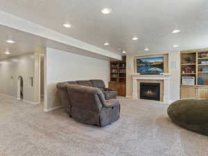 Living room with a fireplace, carpet, and TV