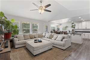 Spacious living room with vaulted ceiling, a ceiling fan, with open floorplan into the kitchen. Great for entertaining.