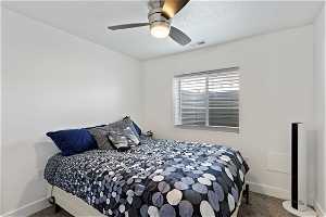 Basement Bedroom featuring a ceiling fan.