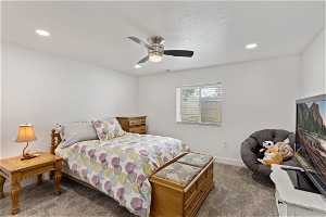 Basement Bedroom with carpet, a ceiling fan.