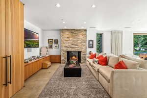 Living room featuring a fireplace, natural light, and TV