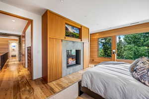 Hardwood floored bedroom with natural light