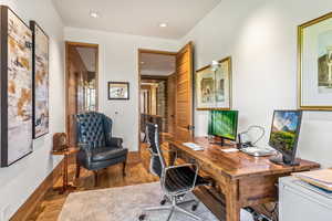 Hardwood floored office featuring TV