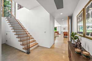 Stairway featuring tile floors and natural light