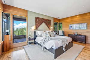 Hardwood floored bedroom featuring natural light