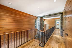 Staircase featuring hardwood floors