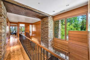 Corridor featuring hardwood flooring and natural light