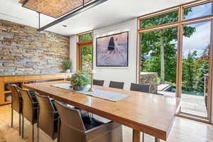 Hardwood floored dining space featuring a healthy amount of sunlight