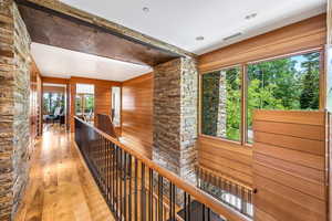 Hallway with hardwood floors and natural light